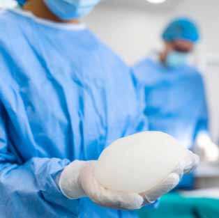 Doctor holding silicone implant. Surgent hold silicone implant.