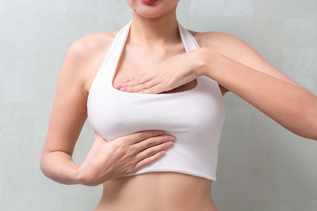 woman feeling her breast for any irregularities