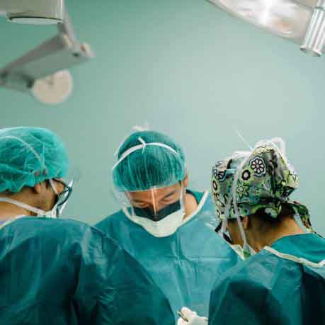 Surgeons performing breast augmentation